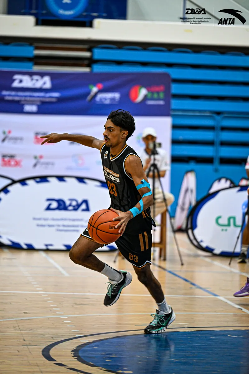 A DOBA player driving to the basket