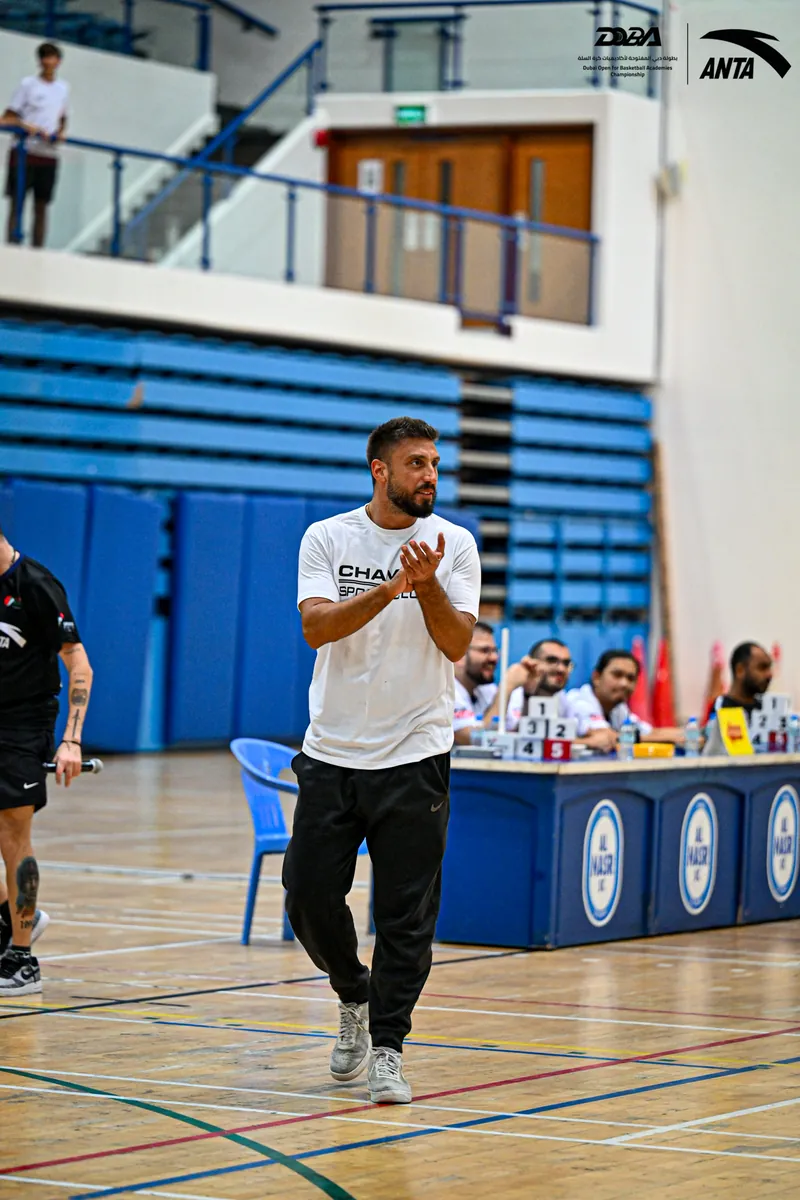 A coach directing his team from the sideline