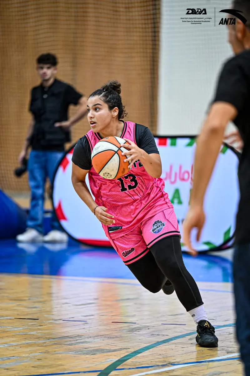 A player in the girls’ division bringing the ball up court